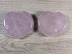Heart-shaped rose quartz bowl by Syn's Crystal Co, featuring smooth pink gemstone with polished surface and intricate heart design.