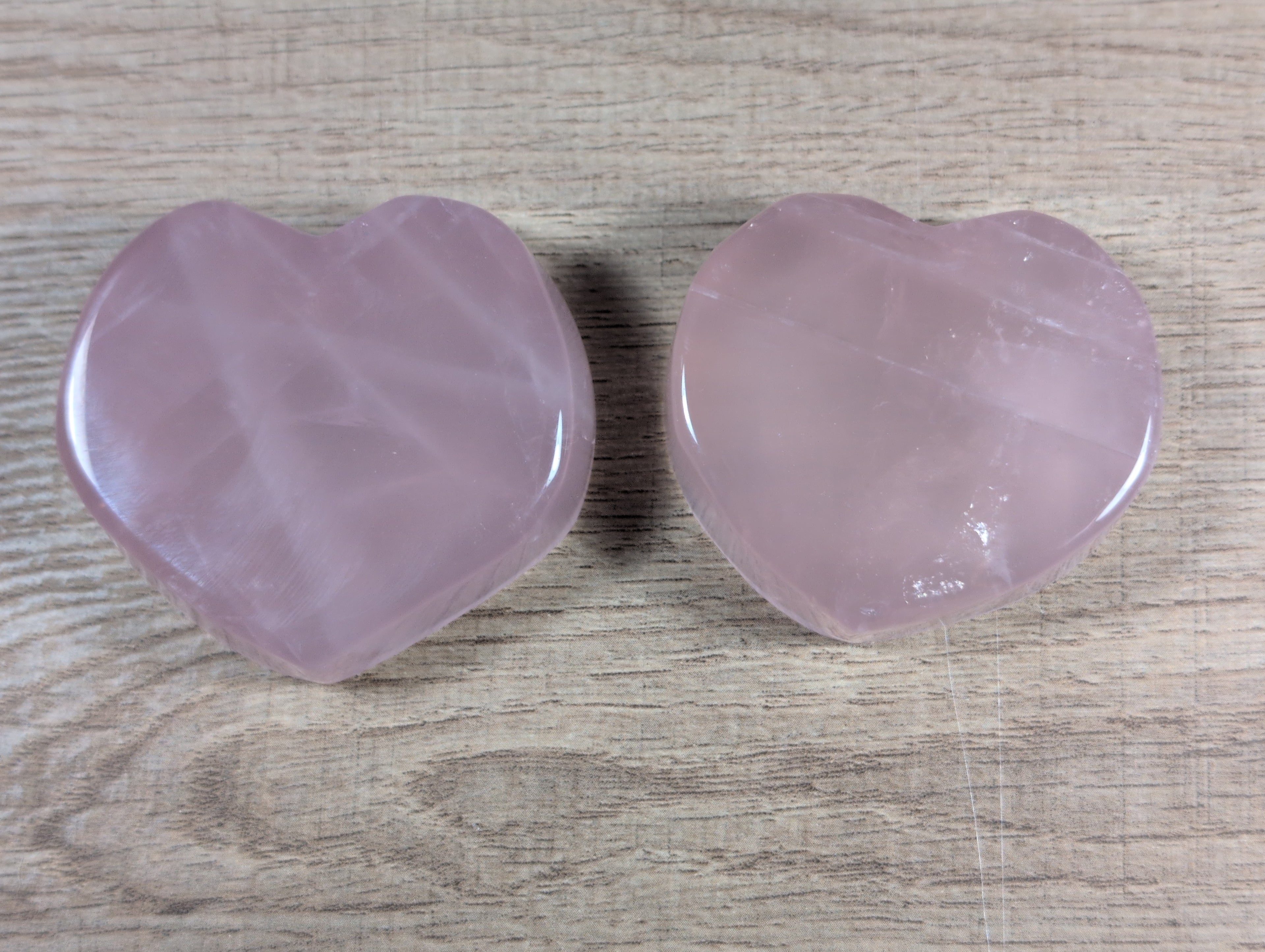 Heart-shaped rose quartz bowl by Syn's Crystal Co, featuring smooth pink gemstone with polished surface and intricate heart design.