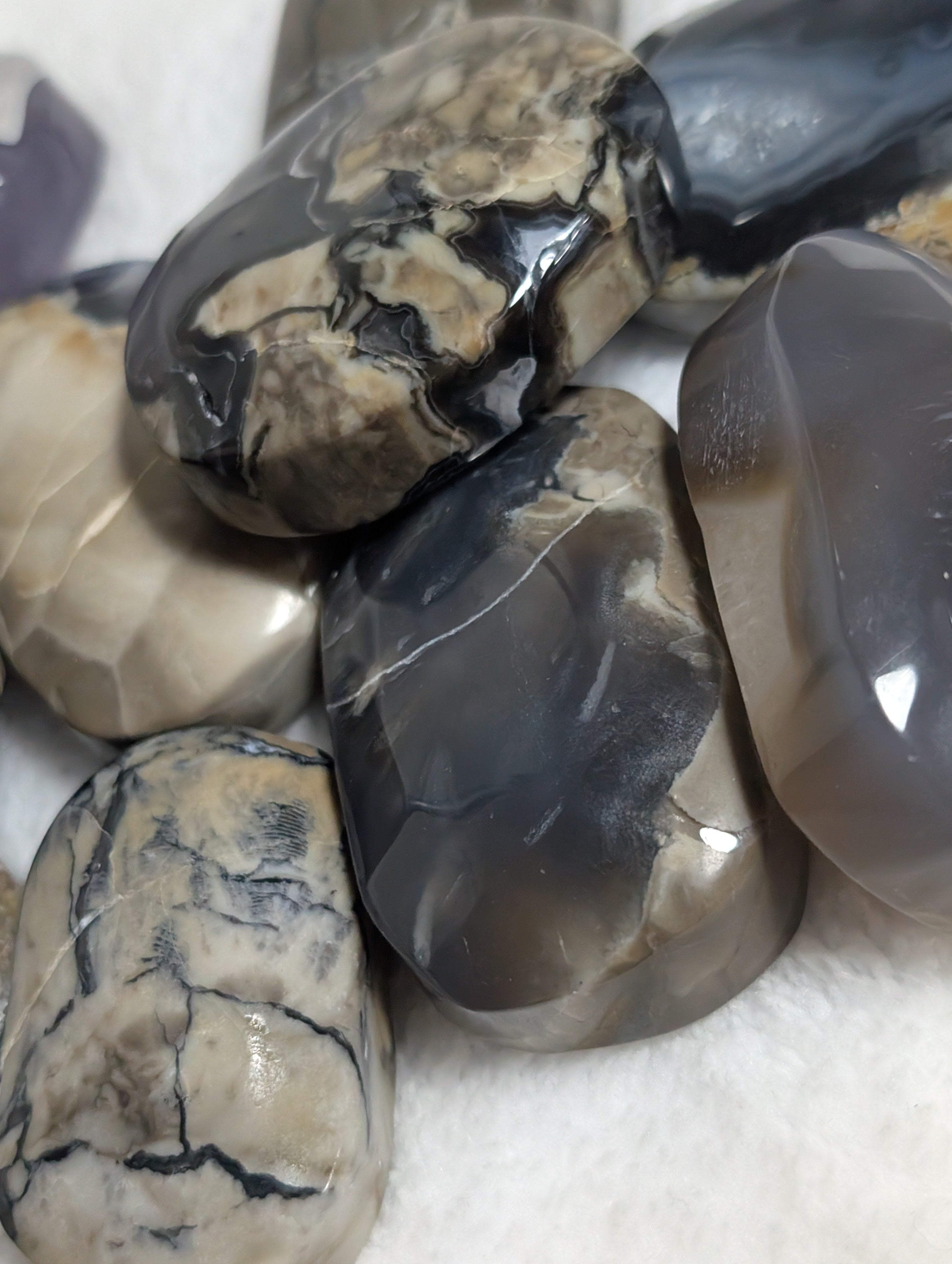 Syn's Crystal Co Volcano Agate palmstone featuring vibrant orange and red swirls, smooth polished surface for meditation and healing.