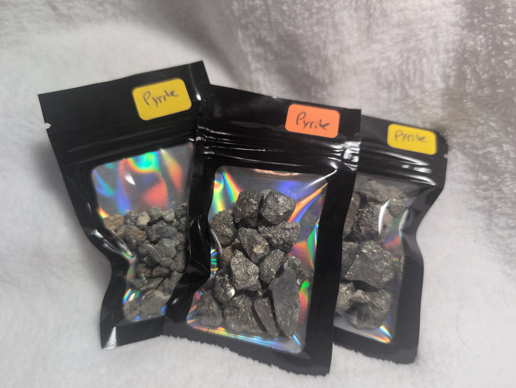 Bag of raw Mookaite crystal chips from Syn's Crystal Co, showing colorful, polished stone fragments in a clear resealable bag.