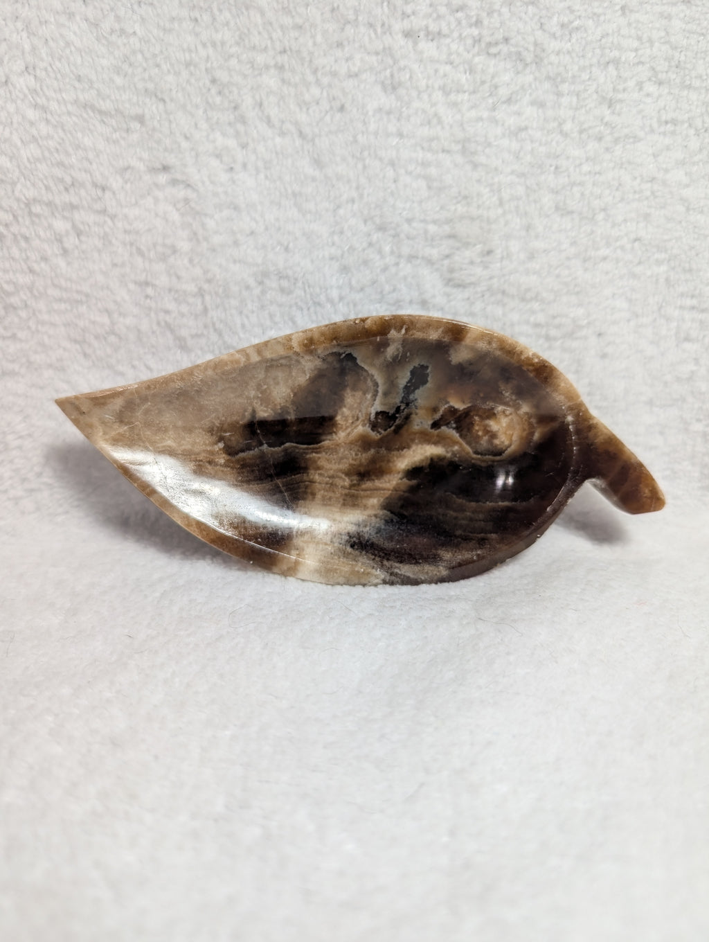 Chocolate Calcite Leaf carving by Syn's Crystal Co featuring a polished chocolate-colored calcite leaf sculpture.