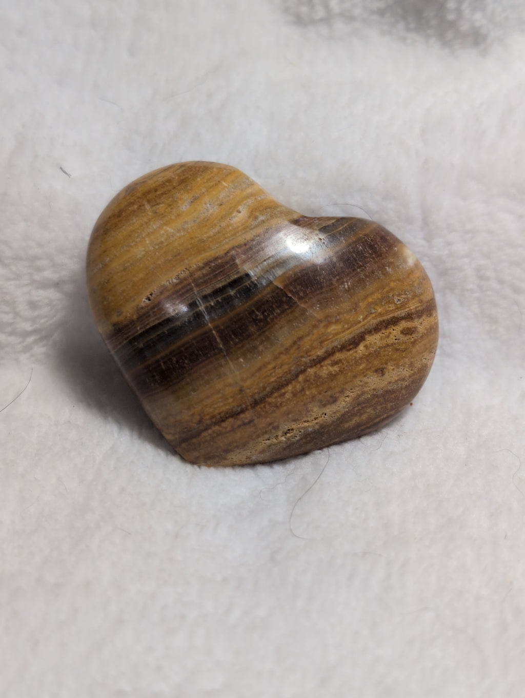 Pink Bumblebee Calcite heart crystal from Syn's Crystal Co, showcasing smooth, polished stone with vibrant yellow and pink hues.
