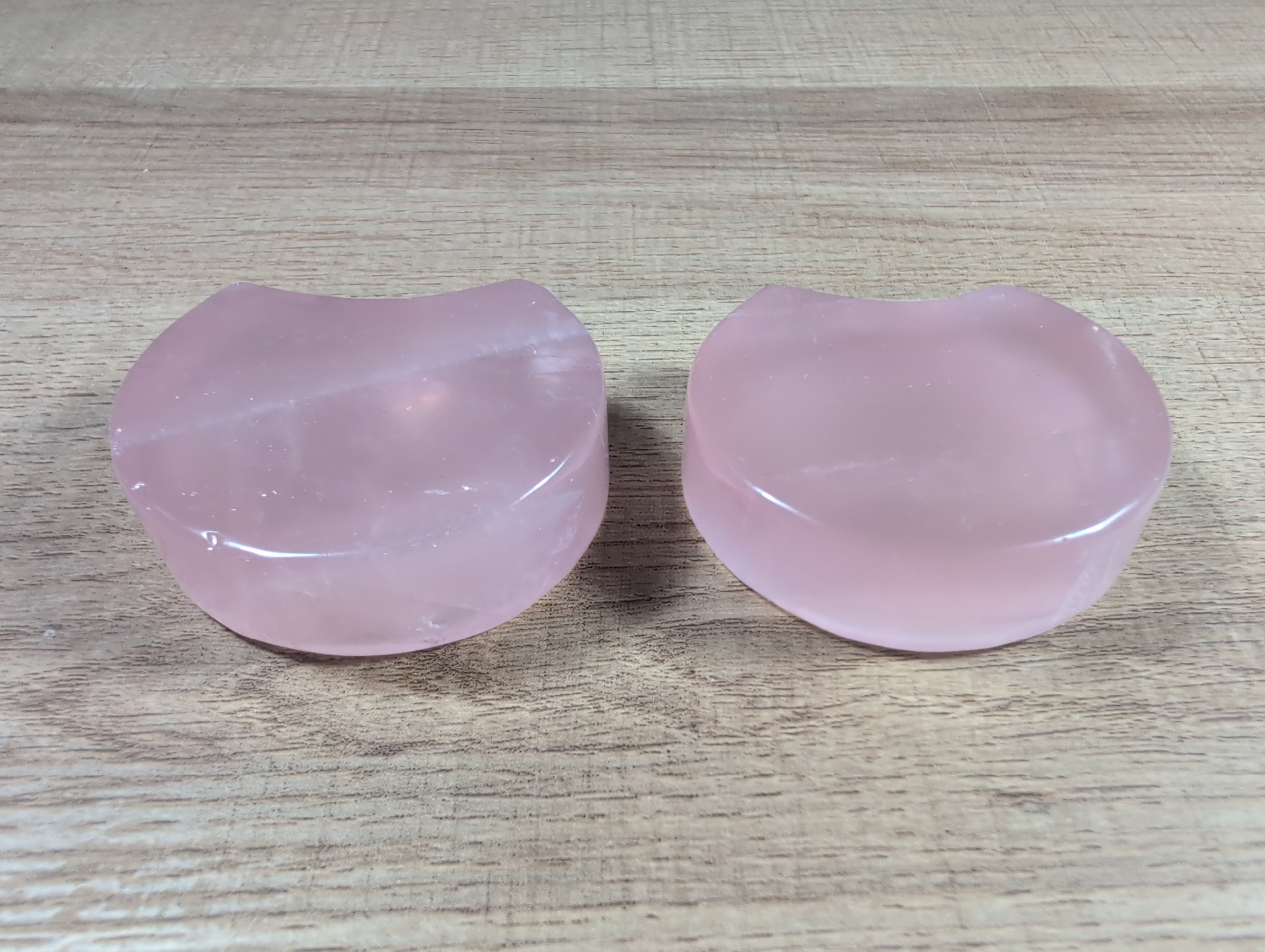 Shaped rose quartz bowl from Syn's Crystal Co, smooth pink gemstone with rounded edges and polished surface.