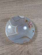 Round Flower Agate bowl from Syn's Crystal Co featuring vibrant floral patterns and polished, smooth stone surface.