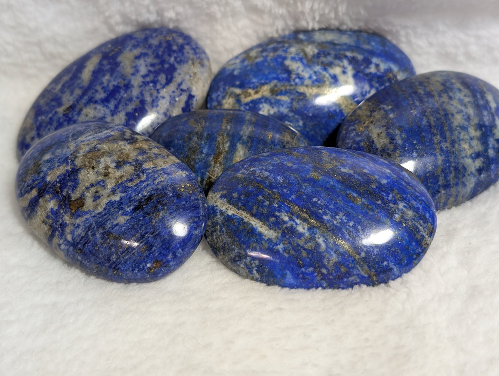 Lapis Lazuli palmstone from Syn's Crystal Co, polished blue stone with gold and white veining, smooth and rounded for meditation.