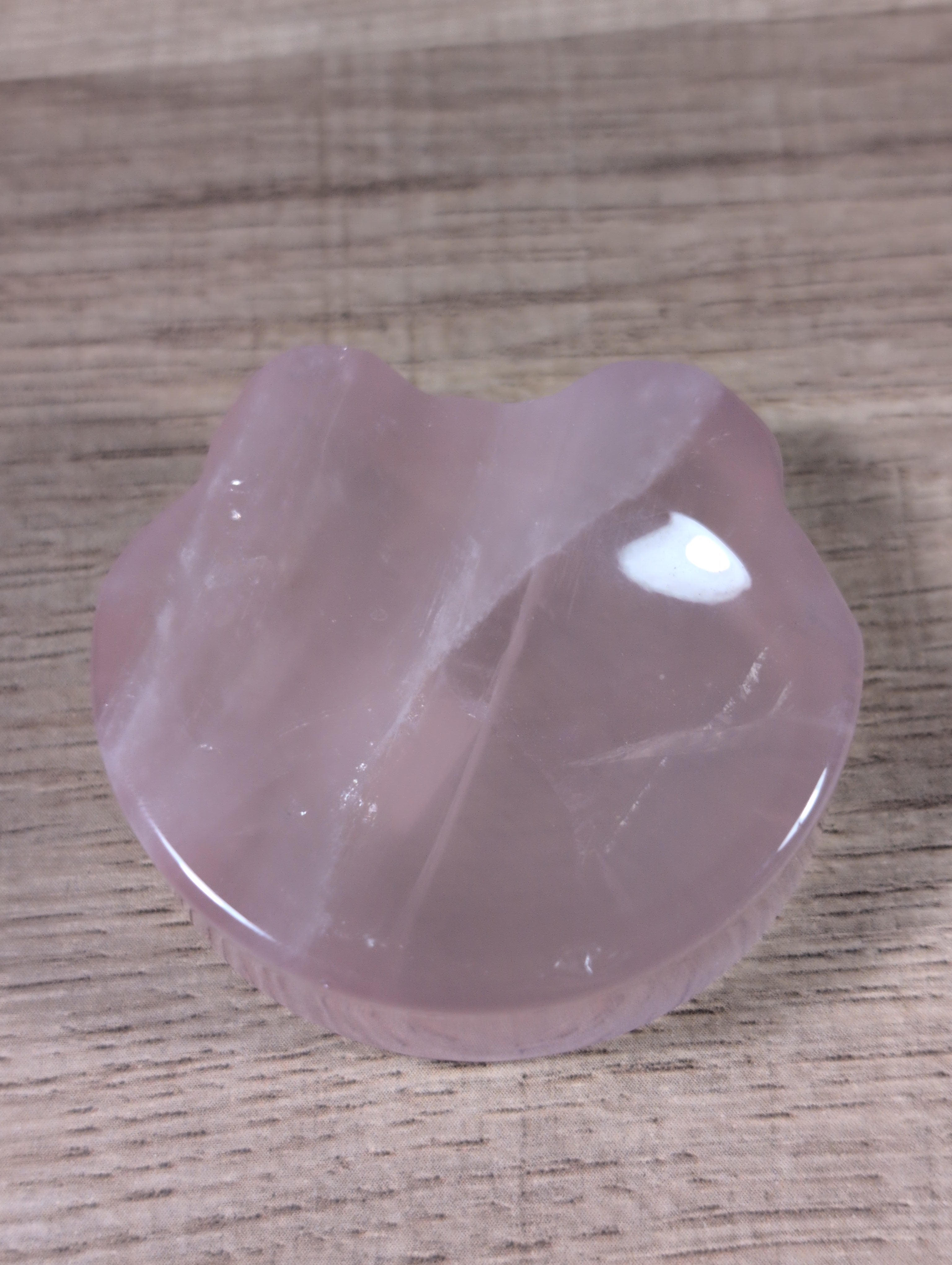 Rose quartz bowl shaped like a teddy bear head with detailed facial features, crafted by Syn's Crystal Co.