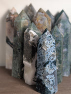 Natural moss agate crystal tower by Syn's Crystal Co, featuring green and brown moss patterns, ideal for grounding and abundance.
