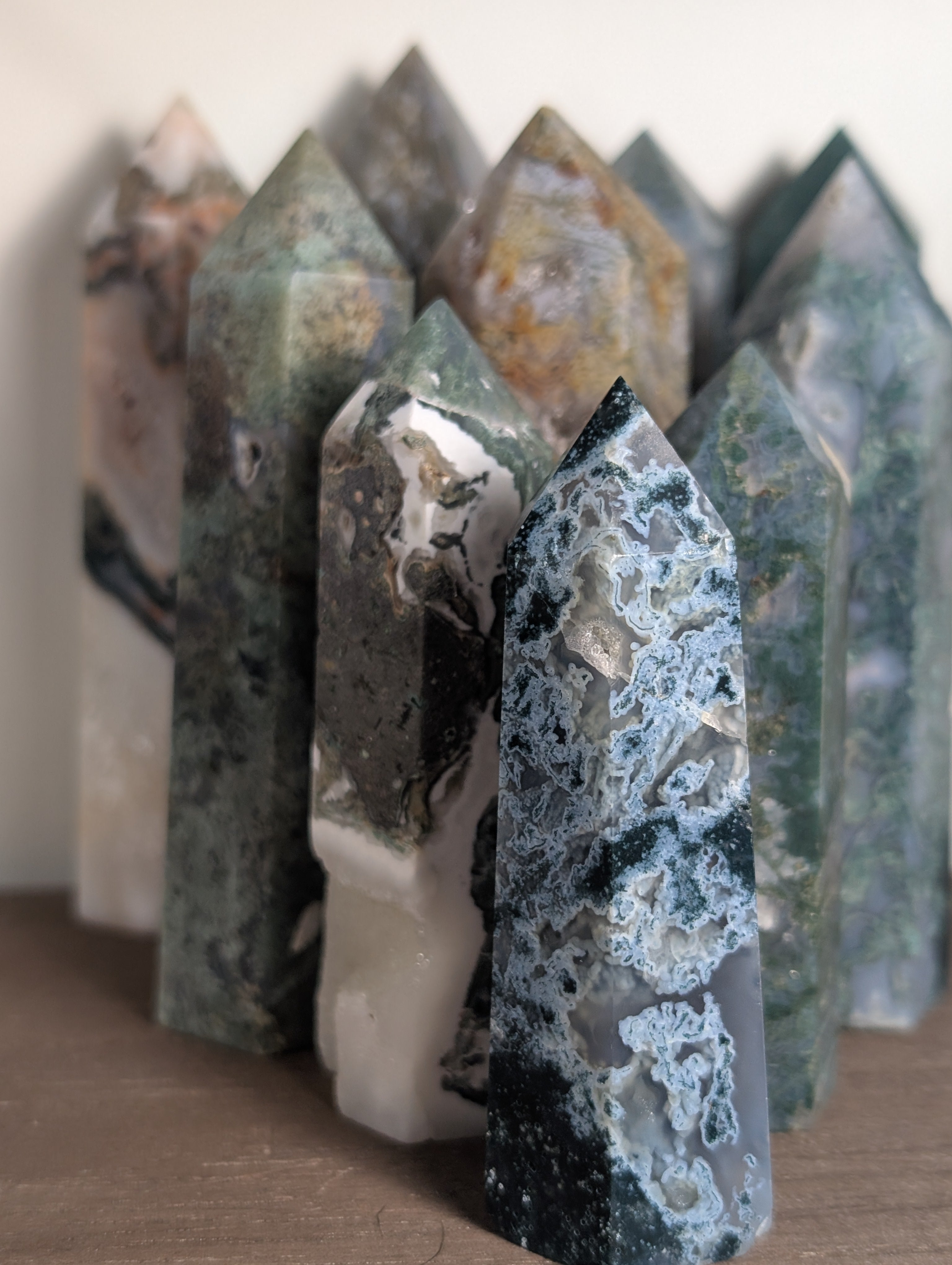 Natural moss agate crystal tower by Syn's Crystal Co, featuring green and brown moss patterns, ideal for grounding and abundance.