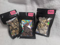 Bag of Mookaite Raw Crystal Chips from Syn's Crystal Co, showing colorful, polished gemstone pieces in a transparent plastic bag.