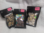 Bag of Mookaite Raw Crystal Chips from Syn's Crystal Co, showing colorful, polished gemstone pieces in a transparent plastic bag.