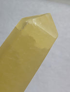 Lemon Calcite tower crystal from Syn's Crystal Co, showing a vibrant yellow mineral with natural crystal formations.