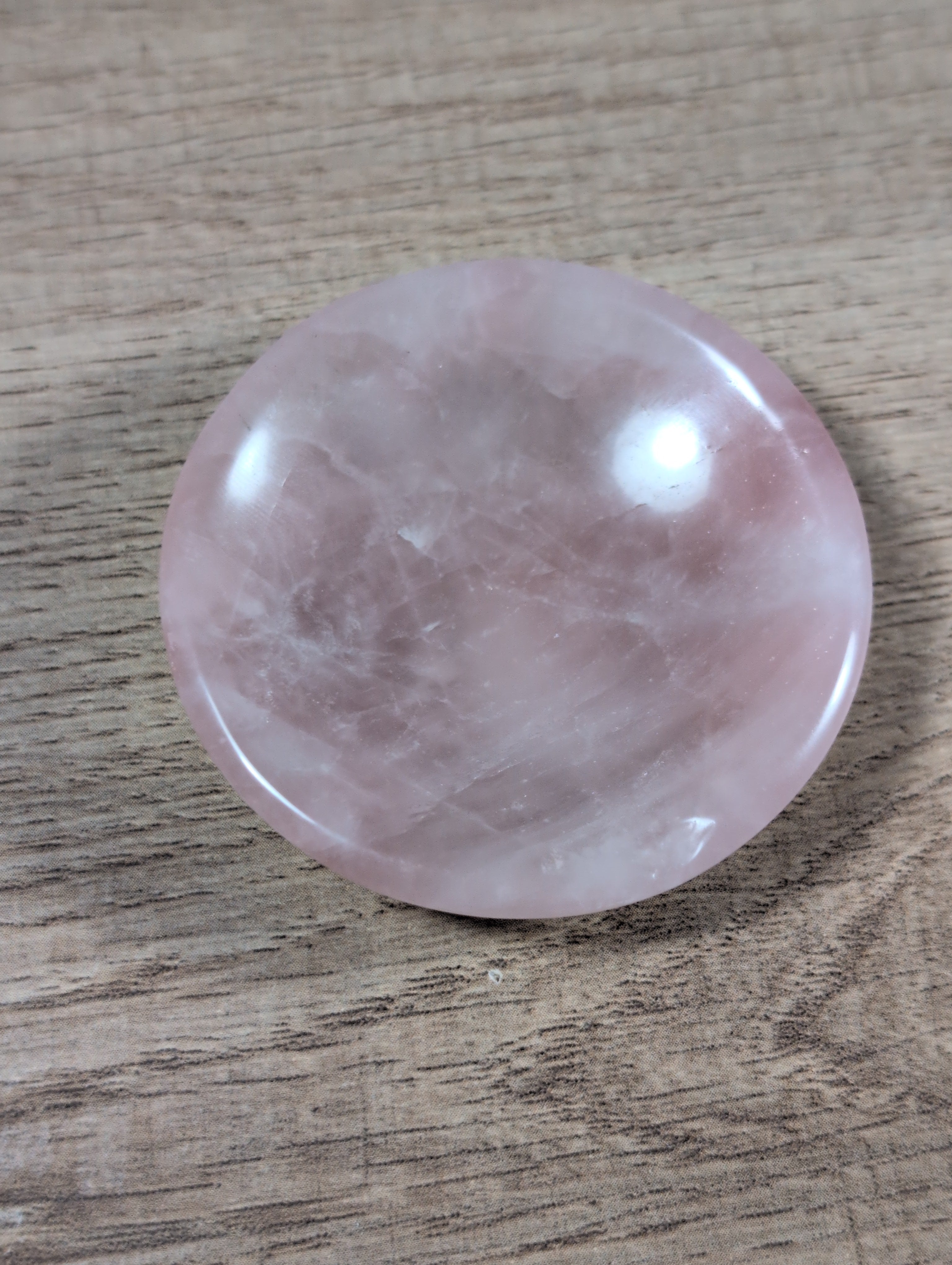 Round rose quartz bowl from Syn's Crystal Co, smooth pink gemstone with a polished finish and rounded shape.