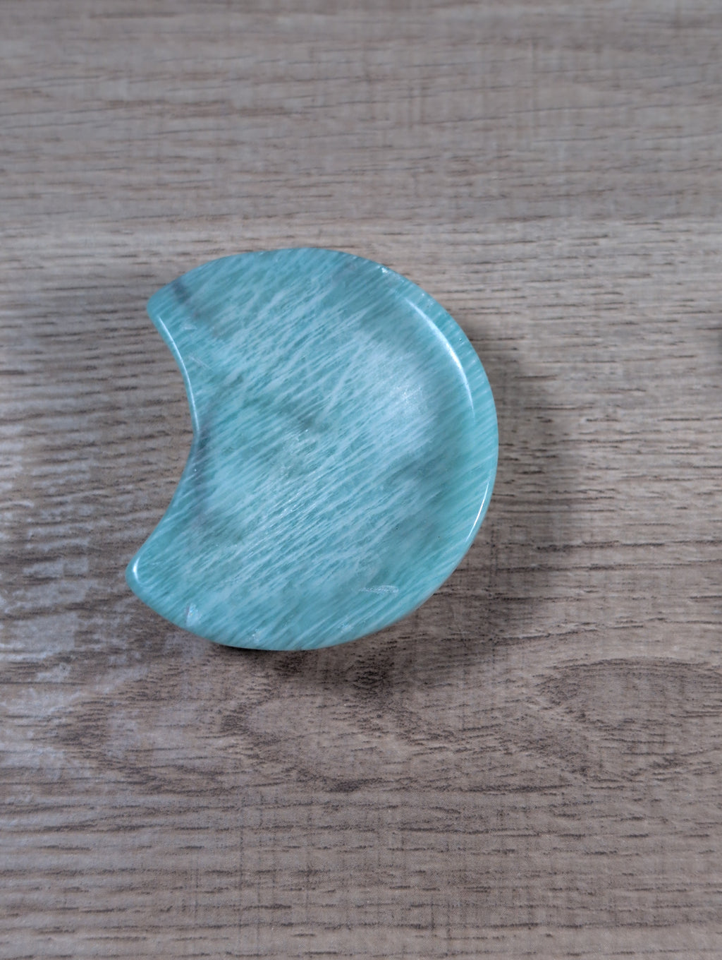Half-moon shaped Amazonite bowl from Syn's Crystal Co, showcasing smooth, polished blue-green gemstone with natural patterns.