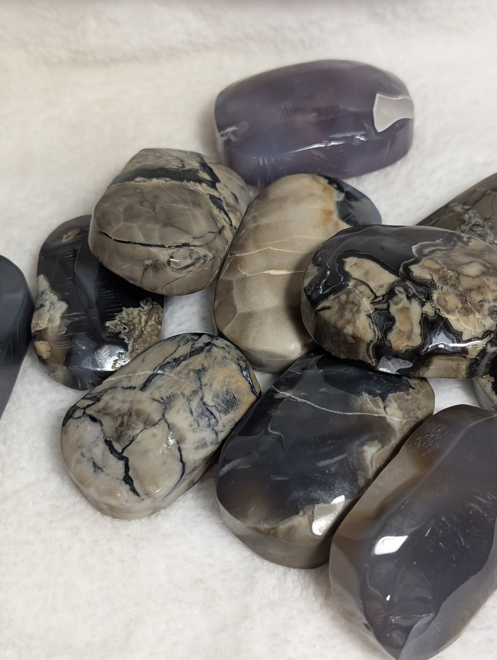 Volcano Agate palmstone from Syn's Crystal Co showing smooth, polished volcanic stone with rich earthy colors and natural patterns.