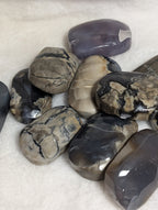 Volcano Agate palmstone from Syn's Crystal Co showing smooth, polished volcanic stone with rich earthy colors and natural patterns.